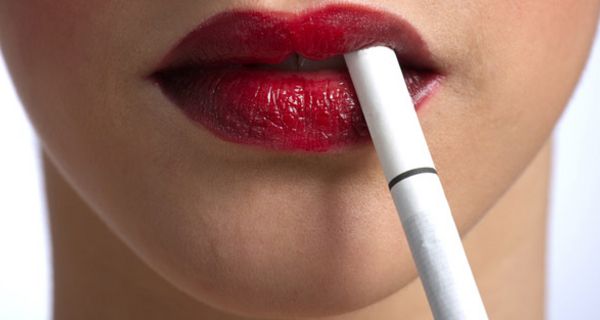 Weiße Zigarette mit roten Lippen