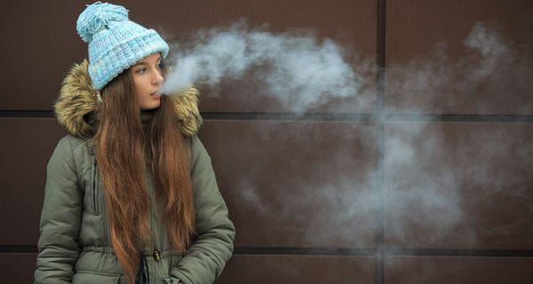 Junges Mädchen, raucht eine E-Zigarette.