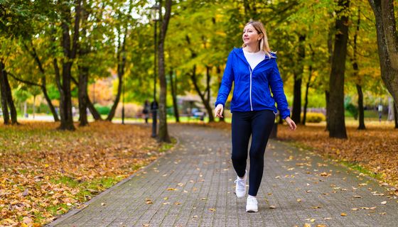 Junge Frau beim Walking im herbstlichen Stadtpark.