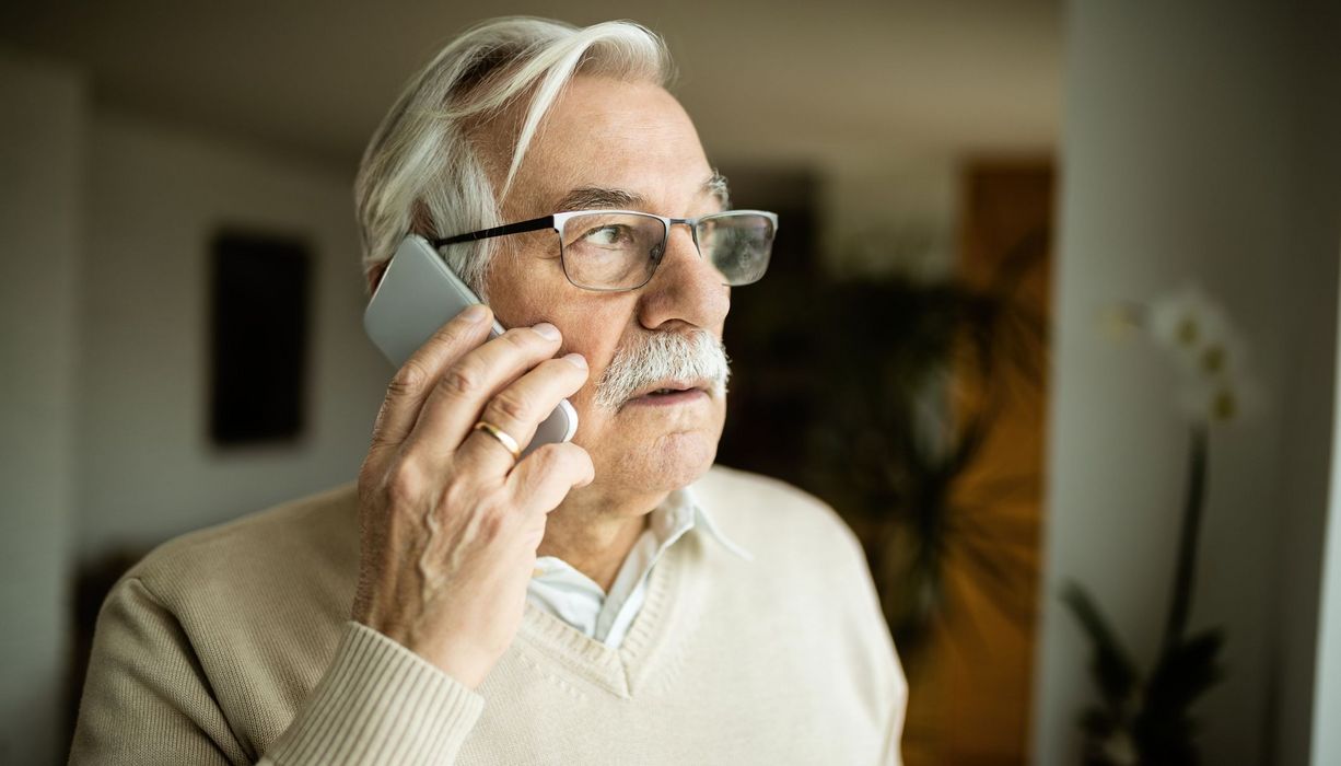 Älterer Mann am Telefon.