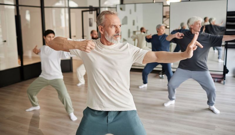 Gruppe, übt Qigong zusammen in einer Sporthalle.