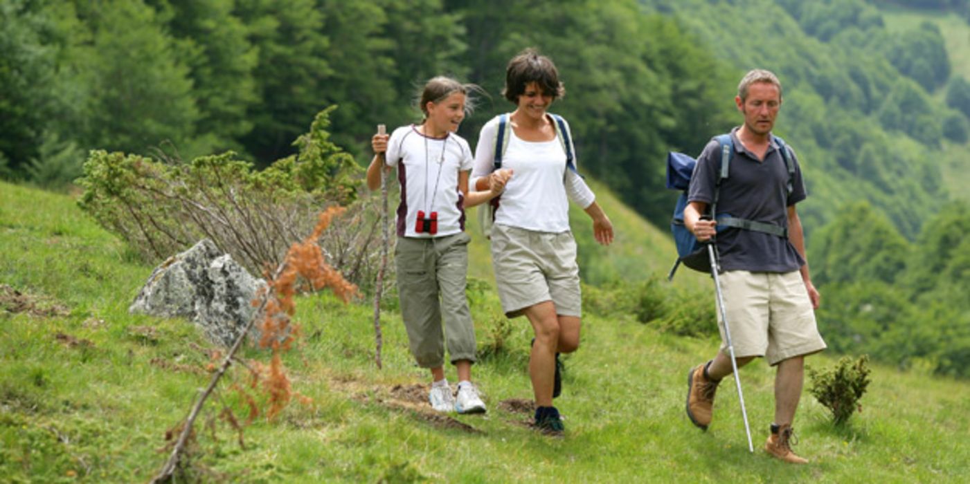 Vater, Mutter und Kind beim Wandern in den Bergen