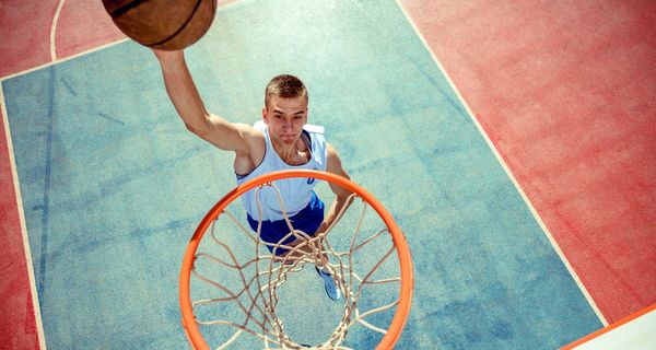 Jugendlicher beim Basketball-Spielen. 