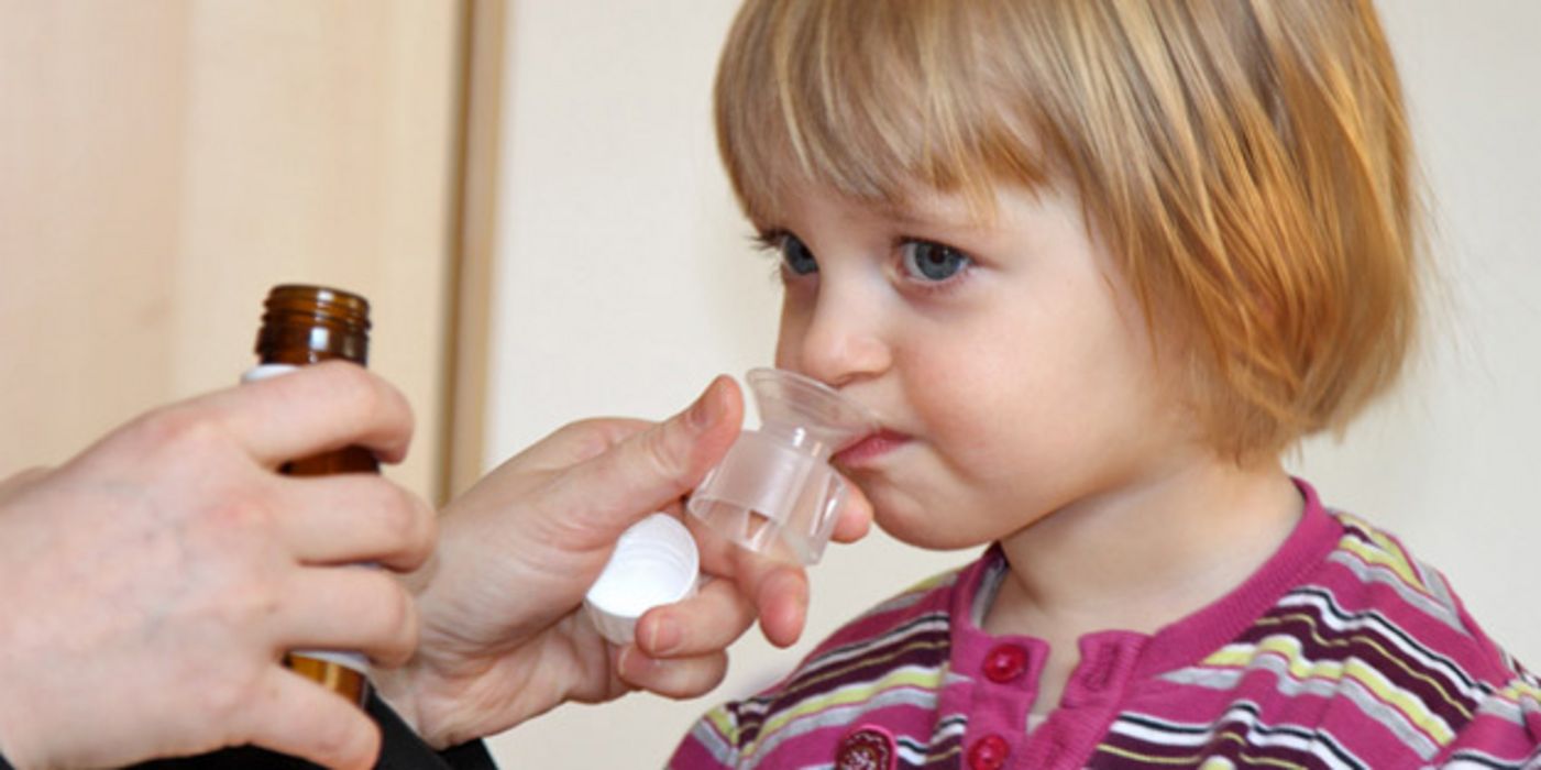 Kind bekommt Antibiotikum-Saft verabreicht