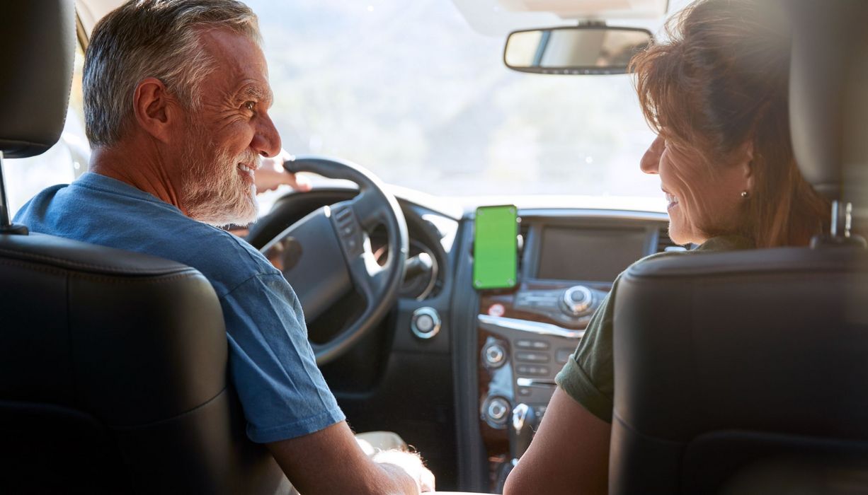 Mann und Frau, ca 60 bis 70 Jahre alt, zusammen im Auto.