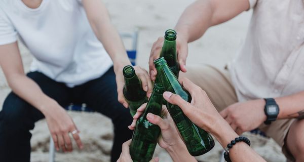 Jugendliche, stoßen mit Bier an.