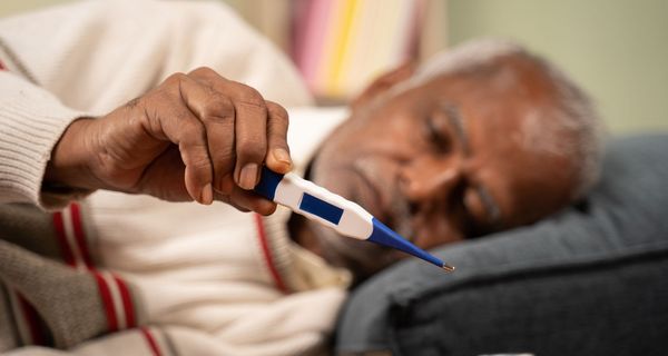 Älterer Mann, misst Fieber.