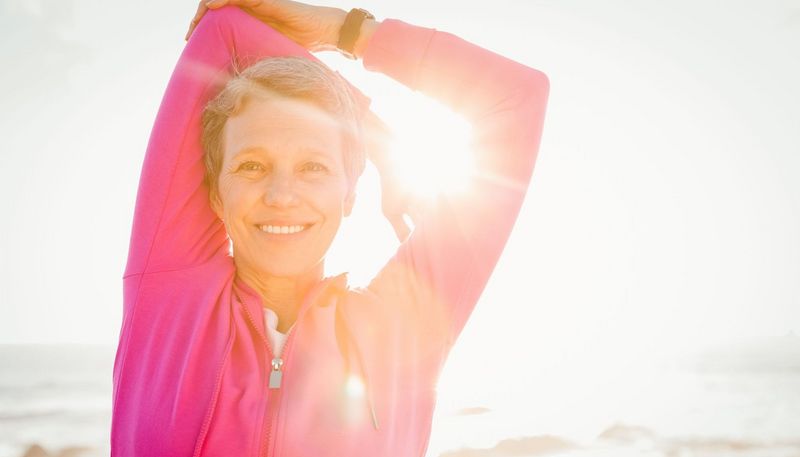 Sportliche Frau mit Sonne im Gesicht