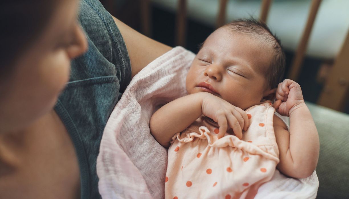 Mutter, hält ihr Baby im Arm.